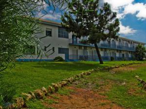 a large building with a tree in front of it at Hotel San Miguel in El Rompido