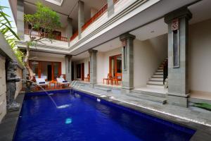 a swimming pool in a villa with a house at Singgah Hotel Seminyak in Seminyak