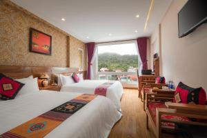 Postel nebo postele na pokoji v ubytování Sapa Luxury Hotel