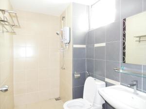 a bathroom with a shower and a toilet and a sink at Wadi Iman Guesthouse @ i-City in Shah Alam