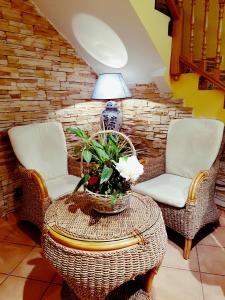 two chairs and a table with a vase of flowers on it at Hostal Maria Ronda in Madrid