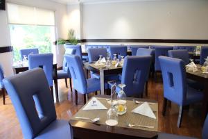 a dining room with blue chairs and tables at P Hotel in Jakarta