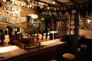 a bar with a lot of bottles on the wall at The Tanners Arms in Devynock