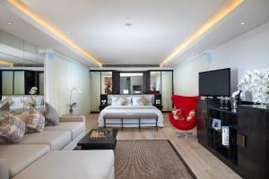 a large living room with a bed and a tv at Double - Six, Luxury Hotel - Seminyak in Seminyak