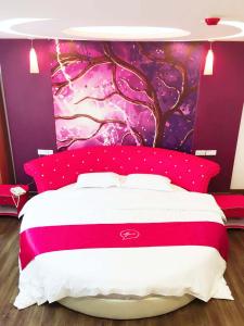 um quarto com uma cama grande e uma parede roxa em Thank Inn Plus Hotel Jiangsu Taizhou Taixing Jingjiang Primary School em Taixing