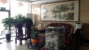 a room with chairs and a table with plants at Thank Inn Chain Hotel Tianjin Jixian Zhongchang Road in Jixian