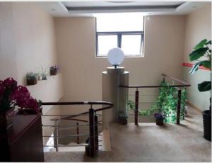 a room with a table and some potted plants at JUNYI Hotel Jiangsu Wuxi Yixing Guibin Avenue in Yixing