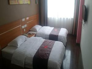 Posteľ alebo postele v izbe v ubytovaní Thank Inn Chain Hotel Shandong Rizhao North Develop Zone Baoshan Road