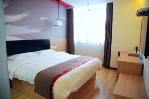 a bedroom with a bed and a large window at Thank Inn Chain Hotel Jiangsu Zhenjiang Danyang Train Station in Jinglin