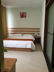 Postel nebo postele na pokoji v ubytování JUNYI Hotel Shandong Zaozhuang Shanting District Xinyuan Road