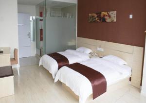 a bedroom with a large bed with white sheets at Thank Inn Chain Hotel Jiangsu Suzhou Wujiang Pedestrian Street in Suzhou