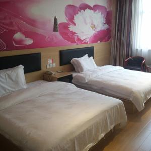 Rúm í herbergi á Thank Inn Plus Hotel Jiangsu Taizhou Xinghua Anfeng Town