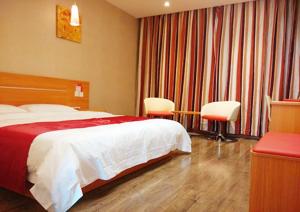 a hotel room with a bed and two chairs at Thank Inn Chain Hotel Shanxi Shangluo Shanyang Nanxin Street in Shanyang