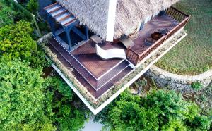 an overhead view of a deck with a bench and a house at Mithi Resort & Spa in Panglao Island