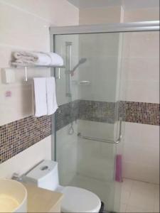 a bathroom with a glass shower and a toilet at Thank Inn Chain Hotel Hubei Wuhan Dongxihu District Jinghe Street in Wuhan