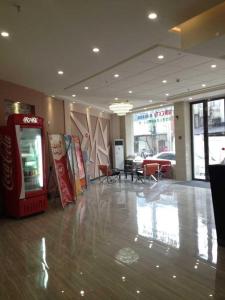a lobby with a cocacola soda machine in a building at Thank Inn Chain Hotel Hubei Wuhan Dongxihu District Jinghe Street in Wuhan