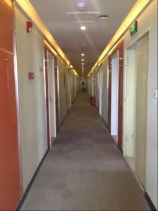 a hallway of an office building with a long corridor at Thank Inn Chain Hotel Hubei Wuhan Dongxihu District Jinghe Street in Wuhan
