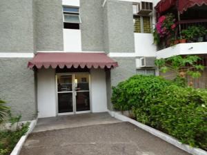 a building with a door with a awning on it at Worthington Towers Apartment in Kingston