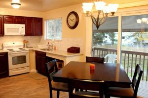 a kitchen with a table and a dining room with a balcony at Brighton Guesthouse (Walk to Metro) in Seattle