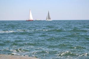 three sailboats in the ocean with a beach at Shalanda in Odesa
