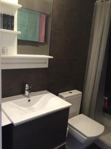 a bathroom with a sink and a toilet at Beach flat with garden in Castelldefels