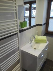 a bathroom with a sink and a towel on a shelf at Ferienwohnung Holzer in Sankt Michael im Lungau