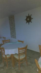 a room with a table and chairs with a spider on the wall at Family Hotel Coral in Sozopol