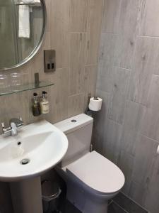 a bathroom with a white toilet and a sink at Carlton Hotel in Ilfracombe