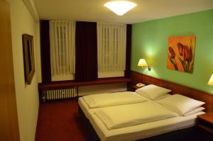 Кровать или кровати в номере Badischer Hof