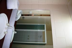 a bathroom with a shower with a glass door at Luma Luma Holiday Apartments in Darwin