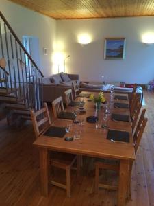 a long wooden table with chairs and a couch at The Old Coach House, Alltshellach Cottages in North Ballachulish +38 photos