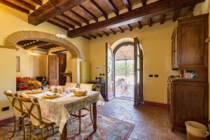 cocina y comedor con mesa y sillas en Casina La Graziosa, en Cortona