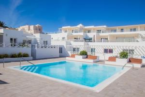 a swimming pool in front of a villa at Flower Beach Suite 6 in Playa Honda