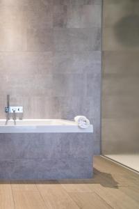 a bathroom with a bath tub with a towel on it at Parkhotel Kortrijk in Kortrijk