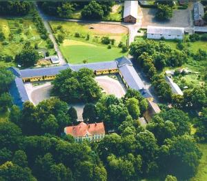 an aerial view of a house with trees and a building at Stado Ogierów Sieraków in Sieraków
