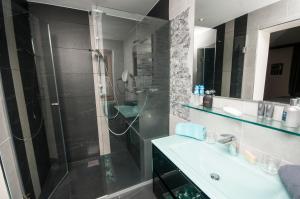 a bathroom with a glass shower and a sink at Landresidenz s'Daham in Heiligenblut