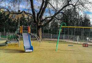 a playground with a slide in a park at Velvet Lazienki Park in Warsaw