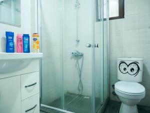 a bathroom with a toilet, shower, and sink at Deeps Hostel Ankara in Ankara