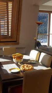 a table with a sandwich and plates of food on it at Apartman Kadic in Bjelašnica