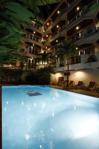a large swimming pool in front of a building at Aonang Sunset Hotel - SHA Extra Plus in Ao Nang Beach