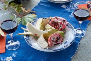 a plate of food on a table with two glasses of wine at Pelion Orama in Agios Ioannis Pelio
