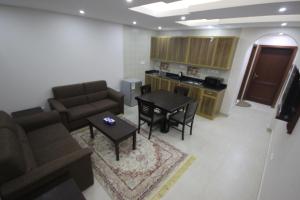 a living room with a couch and a table at Jana Palace Serviced Apartments in Jeddah