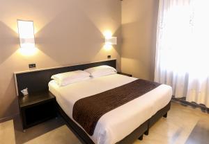 Postel nebo postele na pokoji v ubytování Hotel Mignon