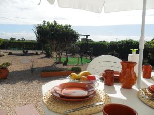 a table with a plate of food on it at Casa Nova da Barreira in Cavaleiro