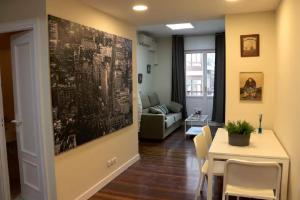 a living room with a table and a dining room at Apartamento Villarias in Bilbao