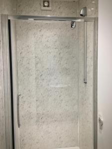 a shower with a glass door in a bathroom at Lagan Backpackers in Belfast