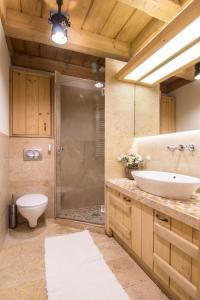 a bathroom with a toilet and a sink and a shower at Apartament Kominkowy Deluxe Zakopane in Zakopane