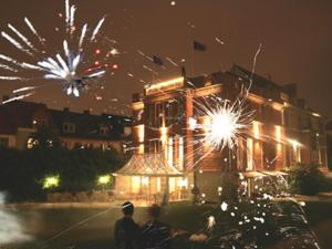 a man standing in front of a building with fireworks at Hotel-Park-Residenz in Aschersleben