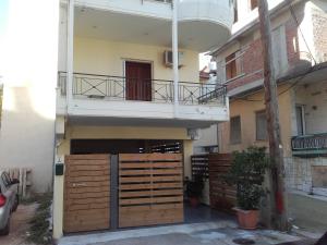 a building with a gate and a balcony at Chris Apartment in Preveza