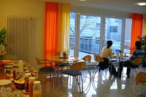 
a person sitting at a table in a restaurant at Hotel Ernst Ludwig in Darmstadt
